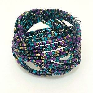 Braided bead cuff bracelet with purple, teal, black, and gold beads.